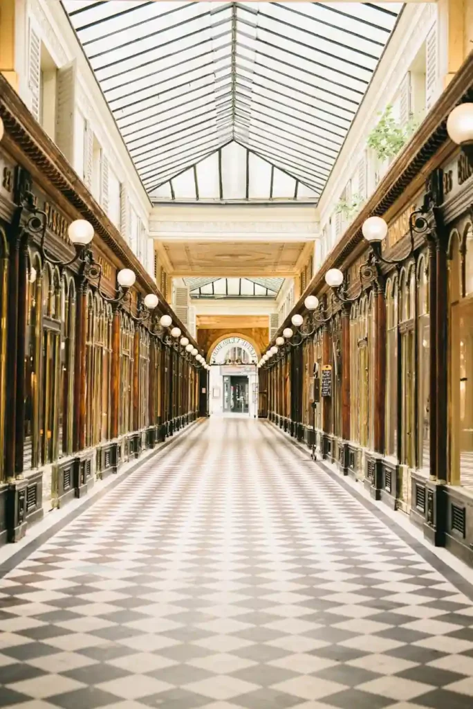 Elegant Parisian passage with vintage storefronts and checkered tile floor, a hidden gem of bespoke Paris itinerary