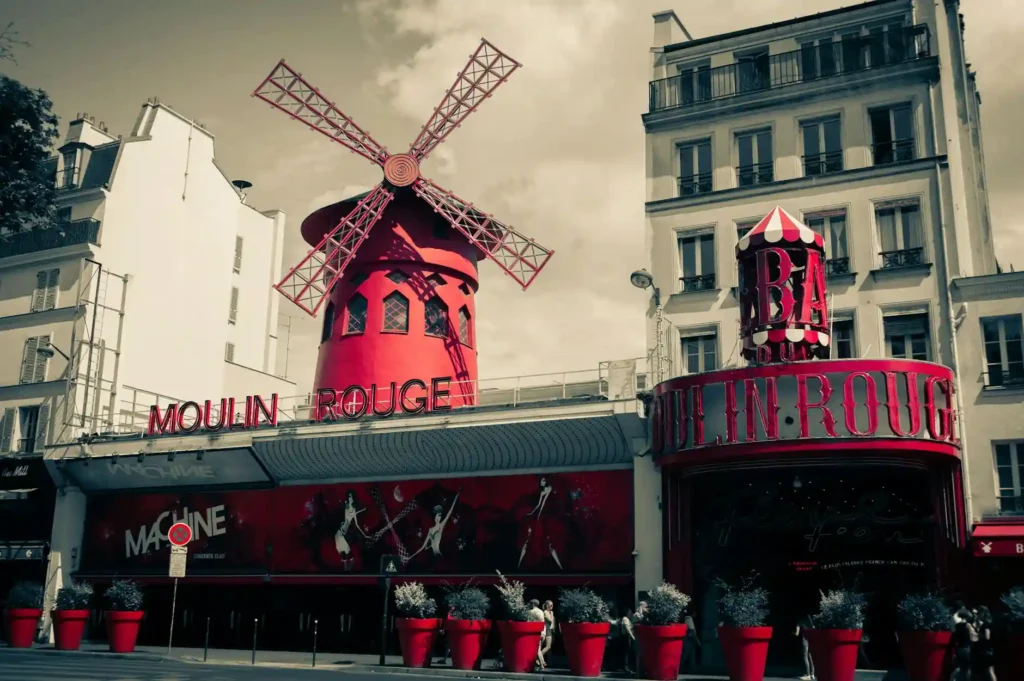 Moulin Rouge cabaret in Montmartre, Paris with red windmill and vibrant façade