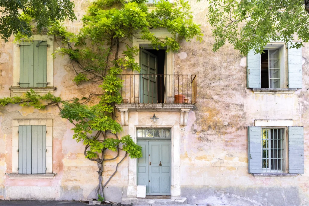 Charming stone house with green shutters in a Provence village