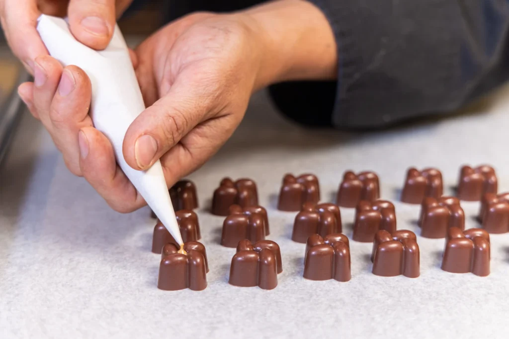 Decorating a chocolate bonbon in a hands-on workshop