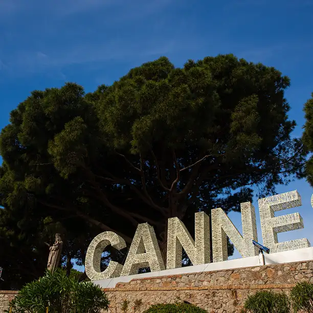 Cannes Hollywood sign with trees and blue sky in background