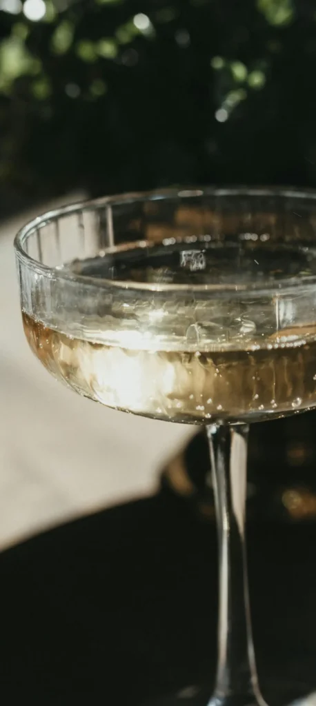 Two champagne glasses in golden light during a celebration in France