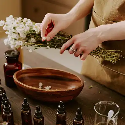 Hands blending essential oils in a custom perfume atelier