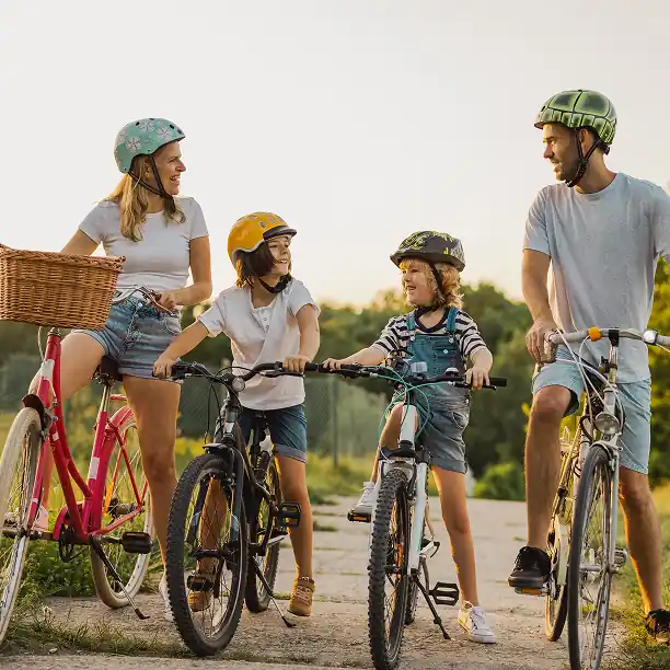 Parents and kids on a bike ride with a luxury picnic basket