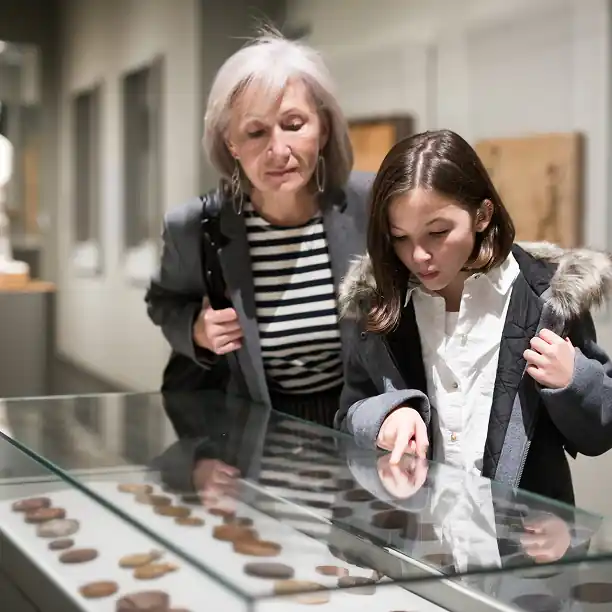 Grandmother and granddaughter exploring a French museum exhibit