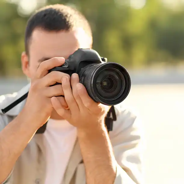 Father taking a picture with a professional camera in France