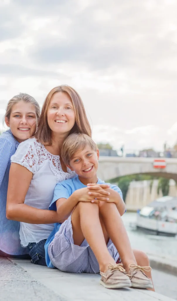 Luxury family vacations in France with a family wearing sun hats relaxing by a river in spring