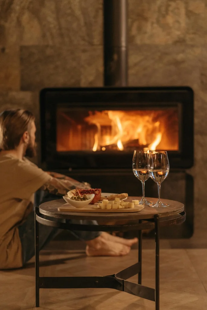 Warm French interior with fireplace, wine and gourmet cheese platter
