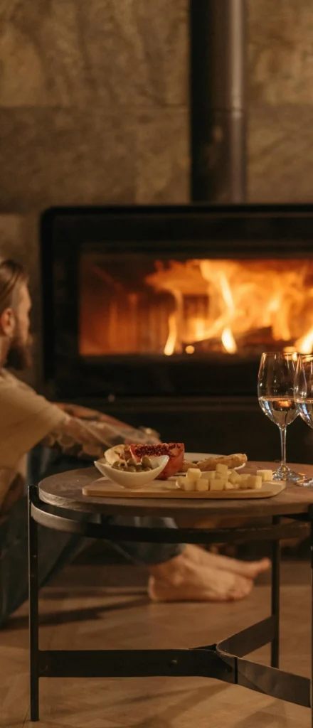 Warm French interior with fireplace, wine and gourmet cheese platter