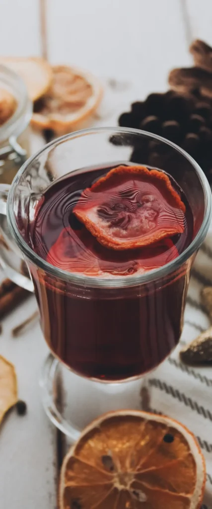 Glass of vin chaud with spices and dried orange slices