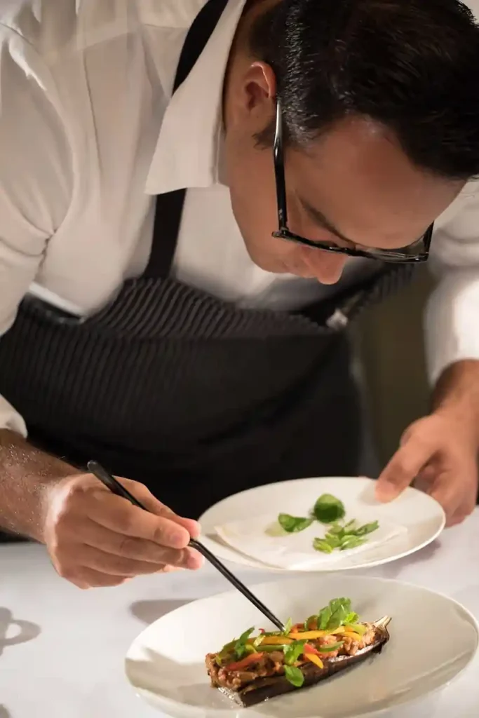 Chef plating haute cuisine in a French restaurant