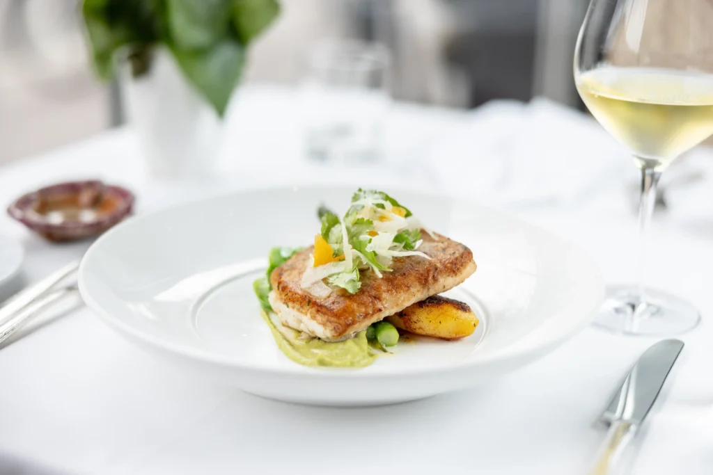 Delicate gourmet dish served with wine in an elegant setting