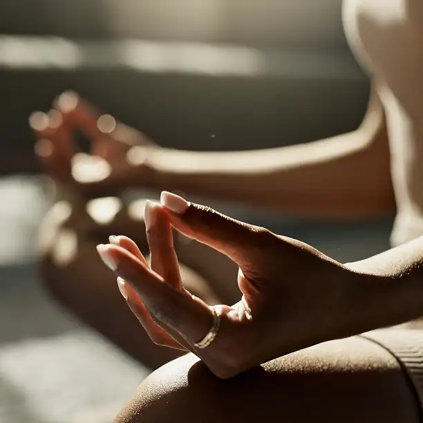 Close-up of a hand in a mudra pose during a wellness meditation