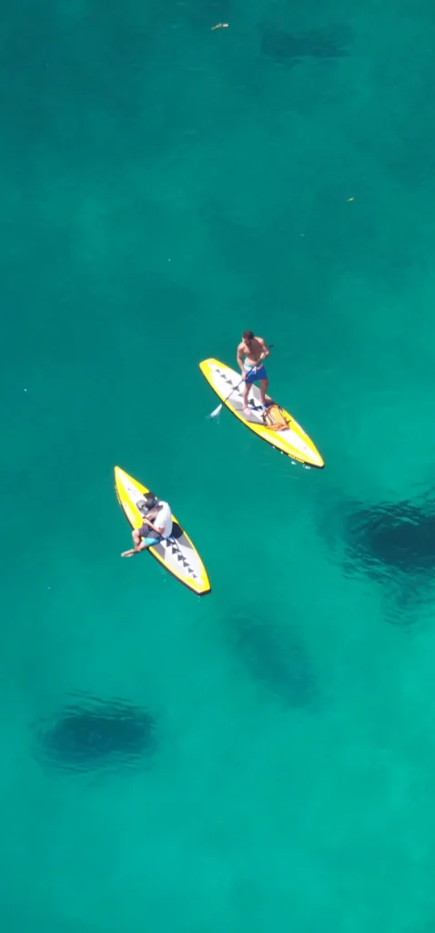 Couple kayaking on crystal-clear turquoise waters of the French Riviera