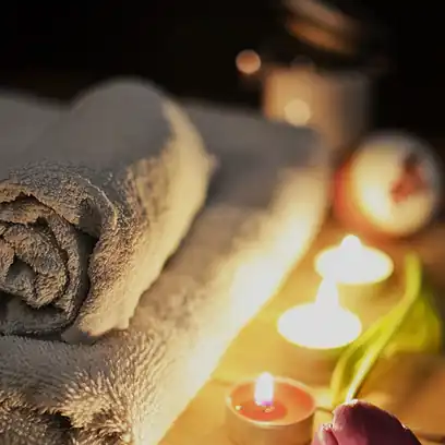Spa towels and candlelit massage table