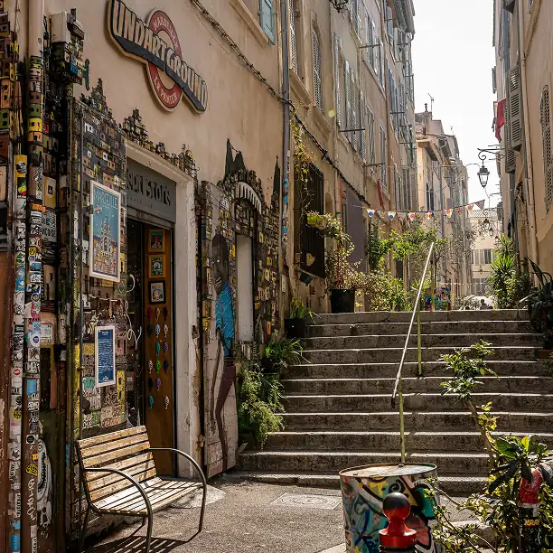 Colorful stairway in Marseille with street art and cafés
