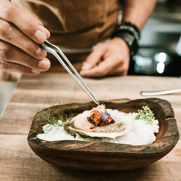 Gourmet Mediterranean dish being prepared in a private seaside villa