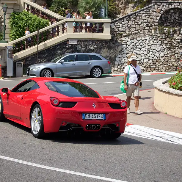Red Ferrari driving on the Monaco Grand Prix circuit road