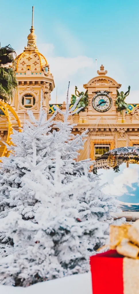 Snow-dusted decorations and gift boxes in front of Monte Carlo Casino