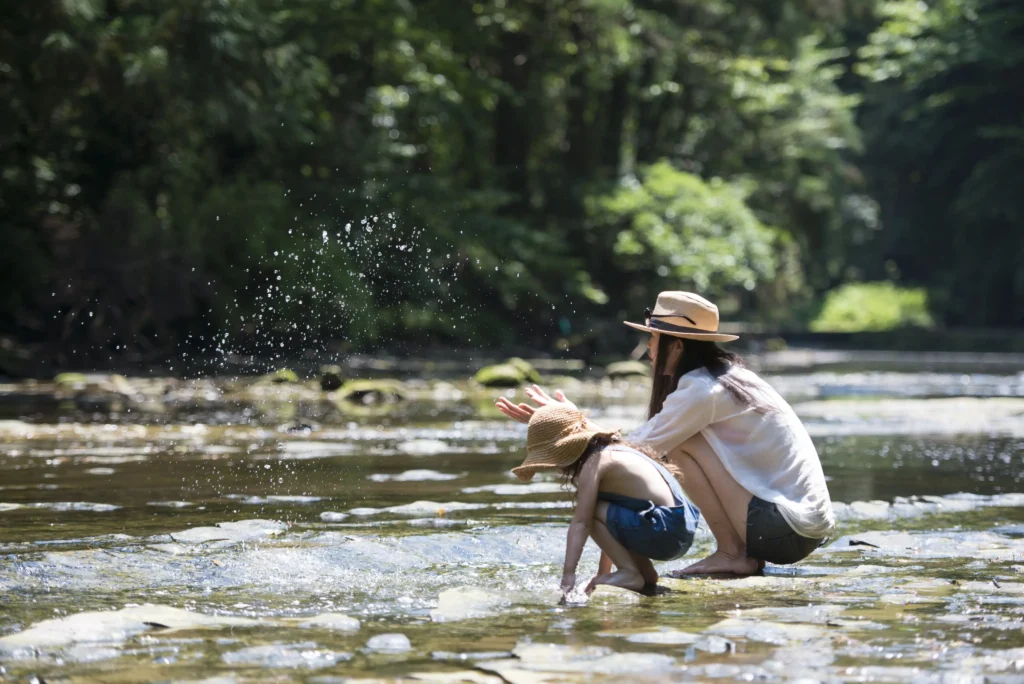 Mother and daughter enjoying time by the river in springtime France