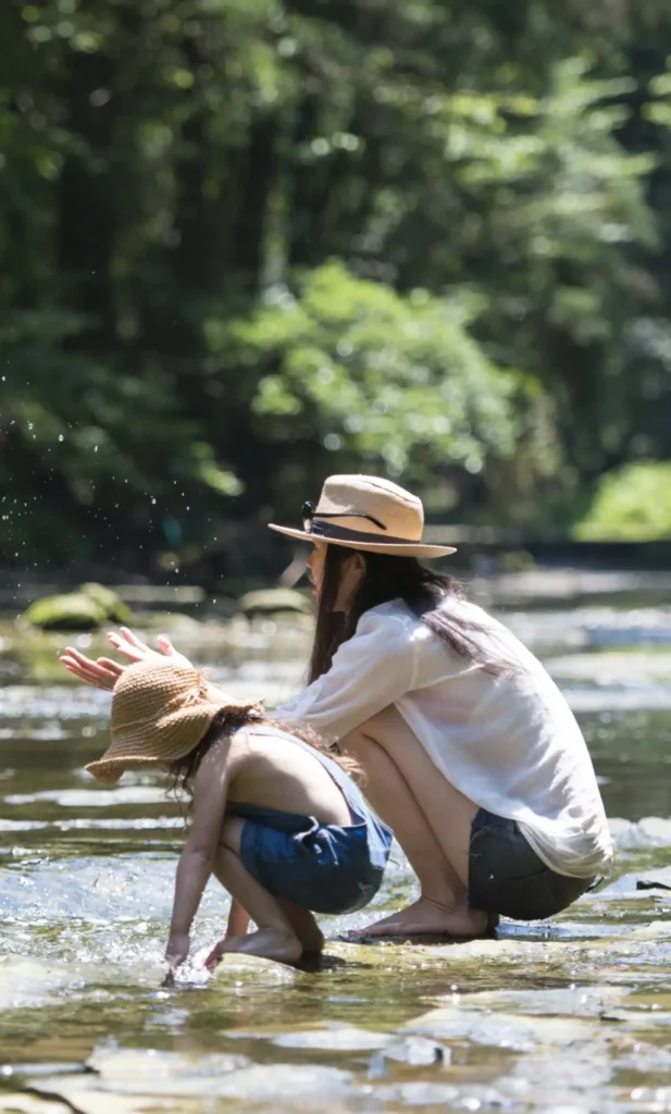 Mother and daughter enjoying time by the river in springtime France