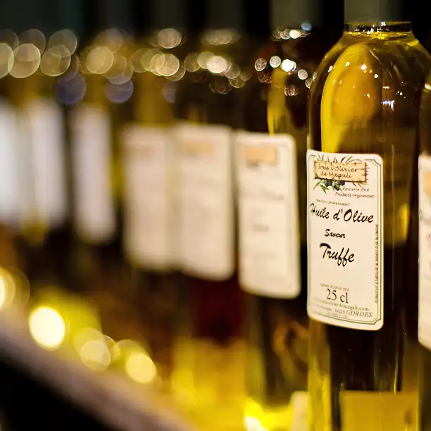 Bottles of olive oil and wine lined up for a tasting experience
