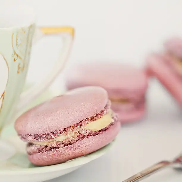 French macaron and tea on a table in a Parisian café