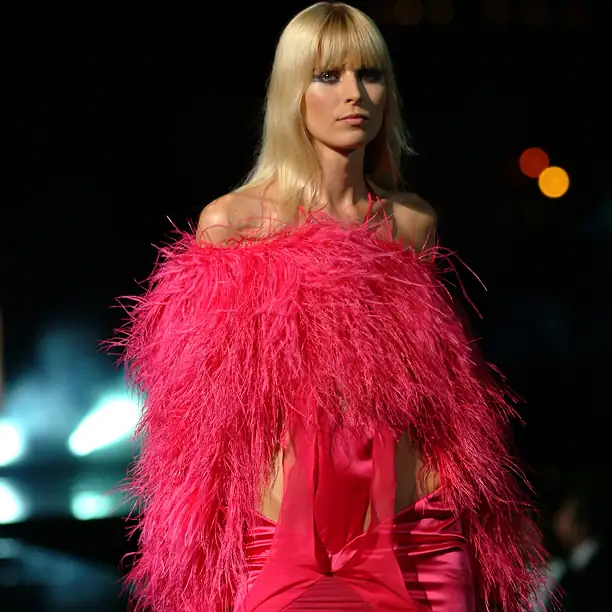 Model in a designer red dress on a Parisian runway