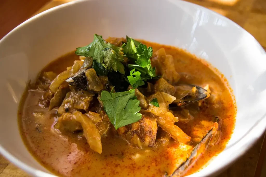 Traditional Provençal stew with eggplant and herbs in a white bowl