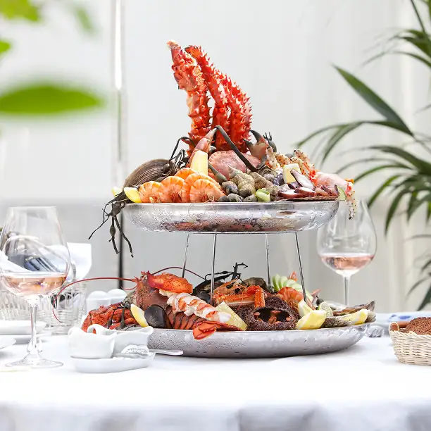 Fresh seafood platter and rosé wine set for lunch by the beach