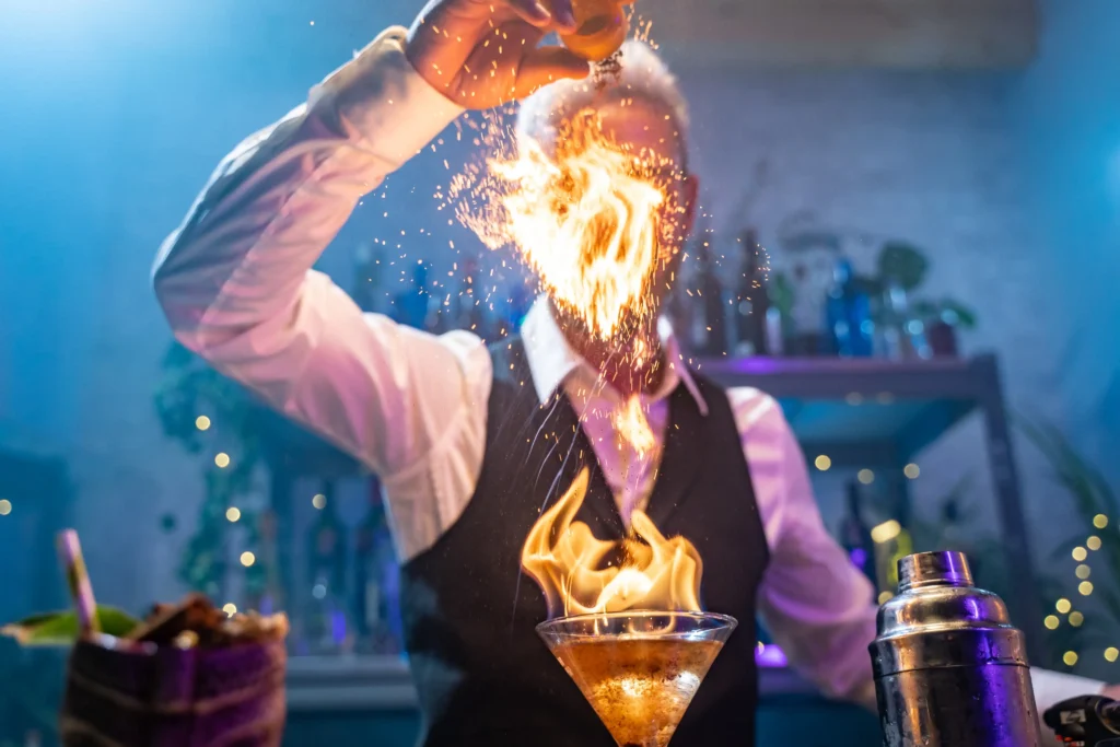 Mixologist crafting a signature cocktail at a luxury bar
