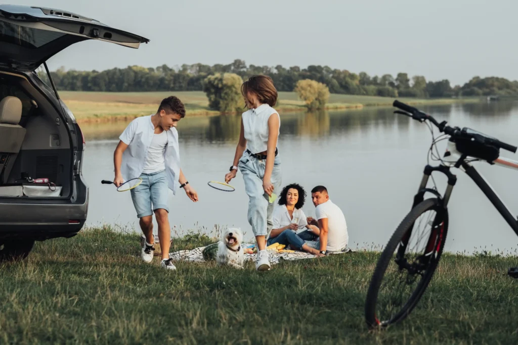 Family toasting with drinks in a lavender field under summer light