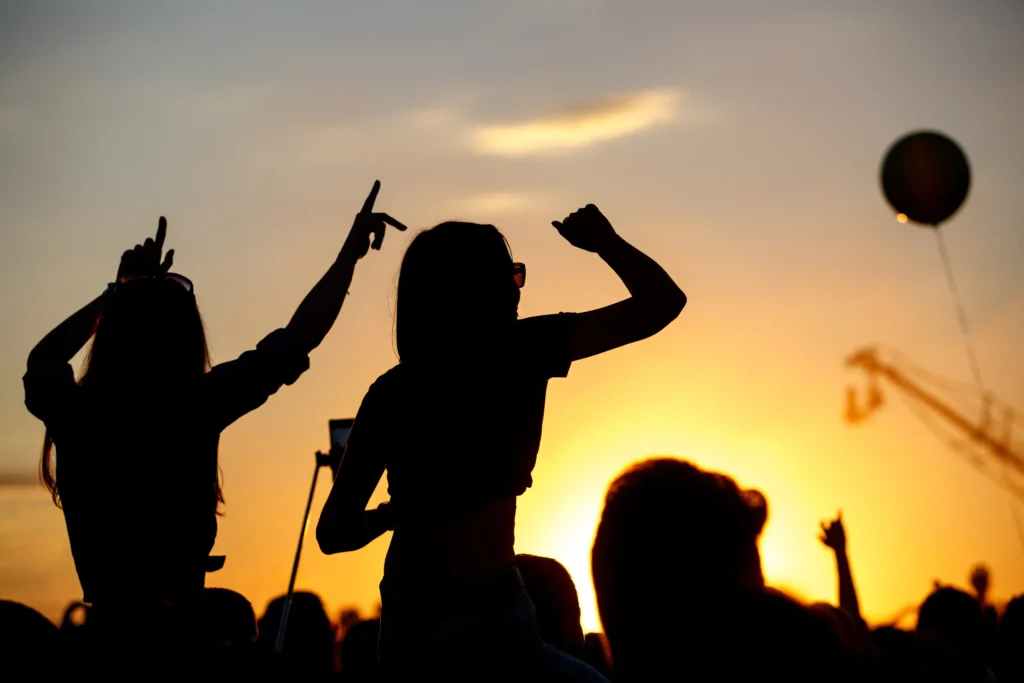 Two women silhouetted at sunset sharing a carefree moment during bespoke girls trips in France