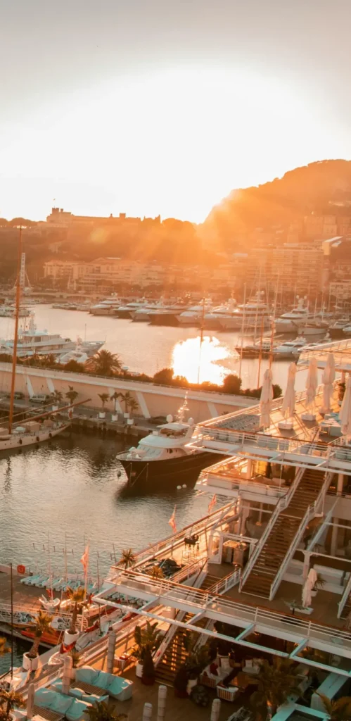 Sailboats moored in a peaceful harbor at sunset in Marseille