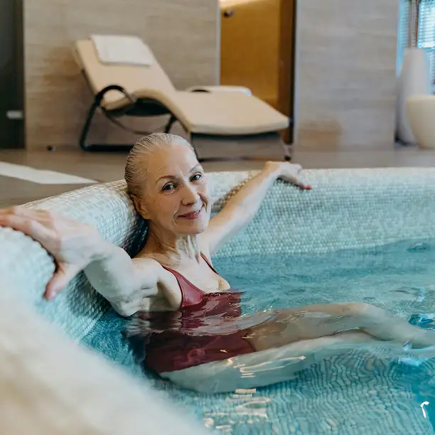 Woman relaxing in an indoor thermal spring spa in France