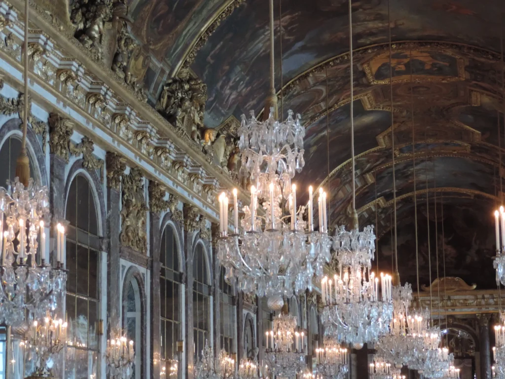 Bespoke cultural journeys in France with a baroque chandelier glowing in an elegant Parisian room