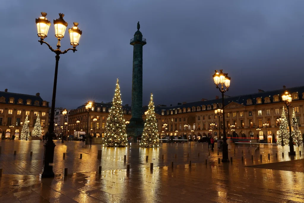 Paris column and streets lit up with golden holiday lights