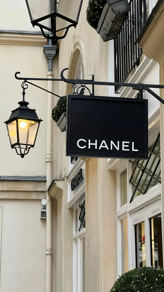 Chanel boutique sign hanging on a Parisian building