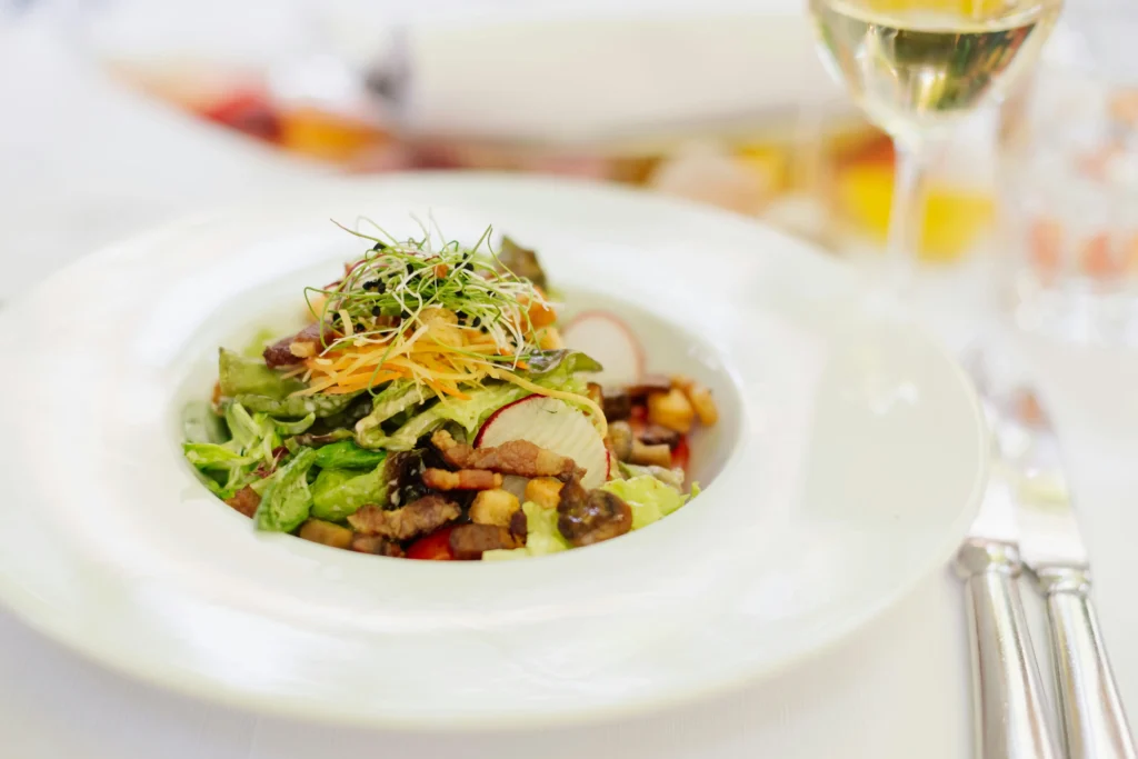 Elegant French gourmet dish served with seasonal ingredients and paired with white wine