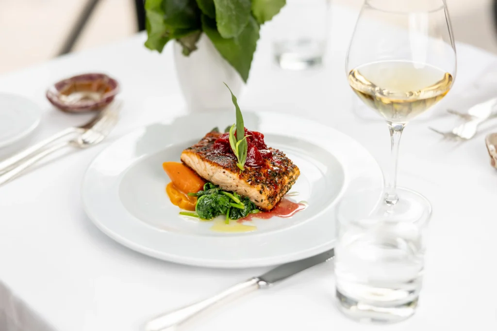 Gourmet fine dining dish with white wine in an elegant restaurant