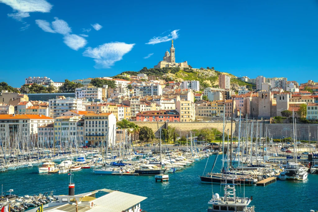 Panoramic view of Marseille’s Old Port with Notre-Dame de la Garde basilica above