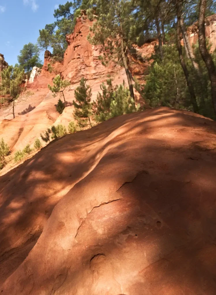 Scenic red ochre cliffs and hiking trail in Roussillon, Provence