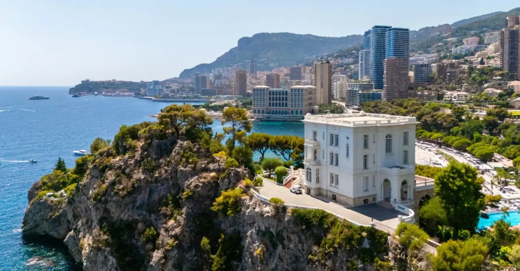 Karl Lagerfeld's France, Breathtaking aerial view of the French Riviera coastline with dramatic cliffs, turquoise Mediterranean waters, and elegant seaside villas