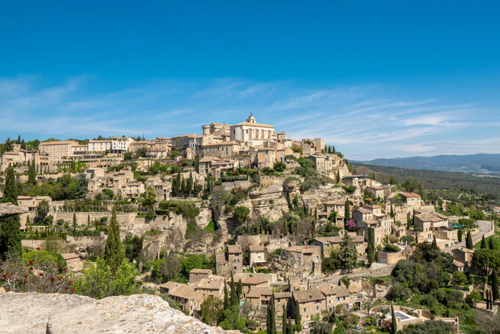 Panoramic view of historic hilltop village in Provence with traditional stone architecture