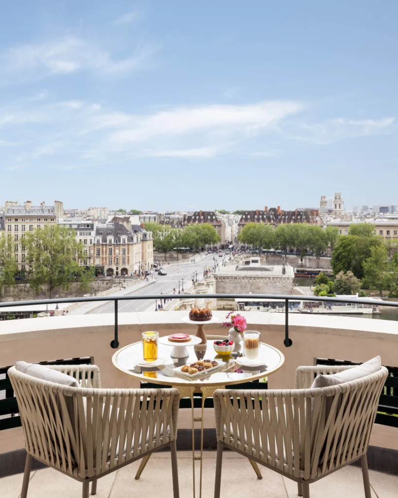 Private balcony terrace from junior suite overlooking Seine River with elegant outdoor dining setup