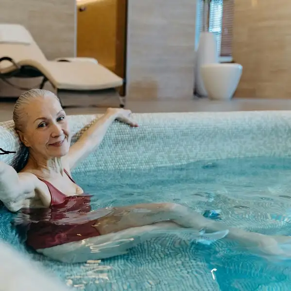 Woman enjoying serene moment at luxury spa infinity pool with elegant minimalist design and natural light