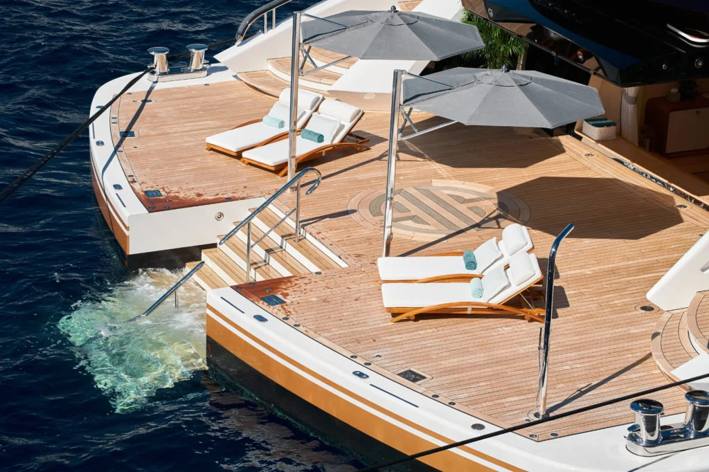 Luxury yacht swimming platform with sun loungers over crystal clear turquoise waters