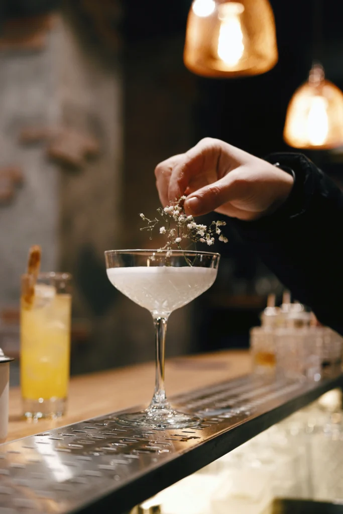 Hand finishing a signature French cocktail at cocktail bars in Monaco