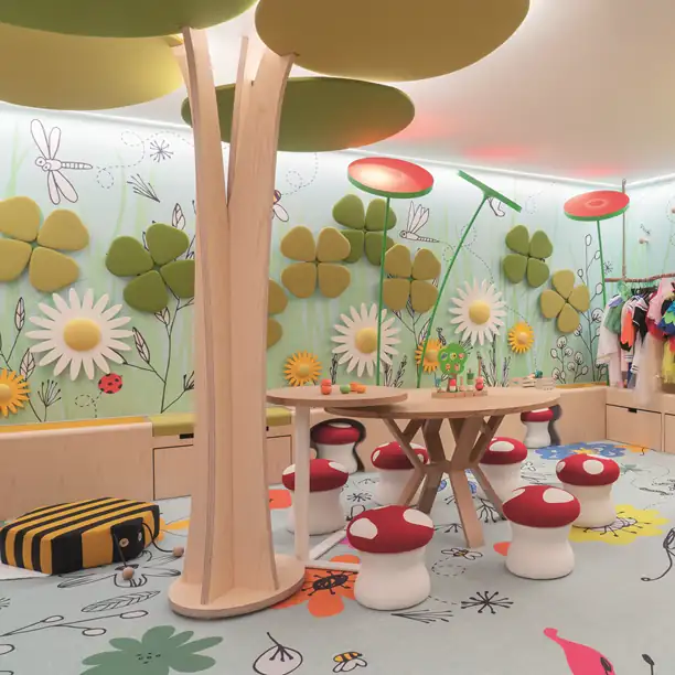 Enchanting carousel-themed luxury dining space with oversized daisy decorations and elegant pink table settings