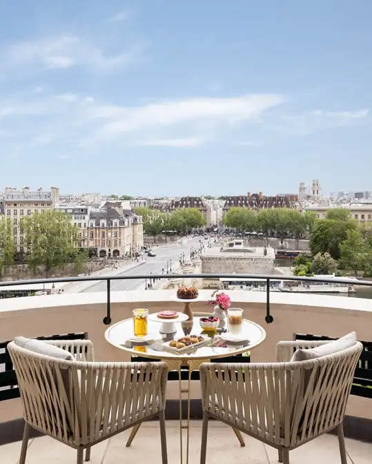 Breakfast served on a private balcony of the Junior Suite Seine at Cheval Blanc Paris with Eiffel Tower views.[memory:2]